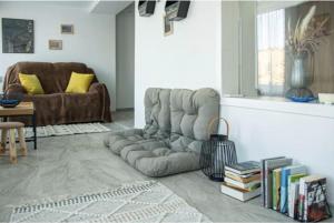 a living room with a couch and a chair at 1 bedroom Lake House in Năvodari