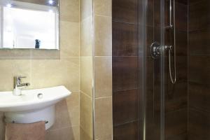 a bathroom with a sink and a shower at Gwithian Holidays in Hayle