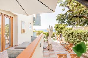 a patio with a table and chairs and a umbrella at Da Umby in Alghero