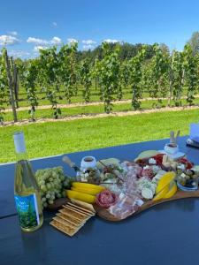 a table with a plate of food and a bottle of wine at The Wine Lodge-Bo på vingård in Vittsjö +30 photos