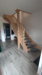 a wooden staircase in a room with wooden floors at Domek na górce 2 in Krościenko