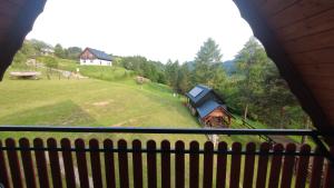 a view from a balcony of a house and a train at Domek na Górce 2 in Krościenko