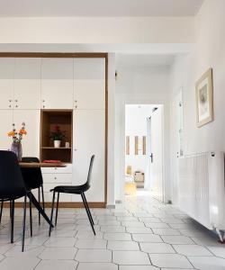 a dining room with a table and chairs in a room at Anna's Apartment in Kato Daratso +13 photos