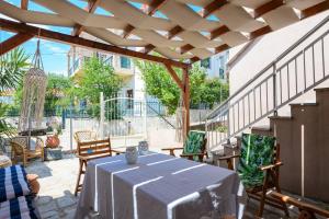 a patio with a table and chairs and a building at Adamou Family House in Prinos