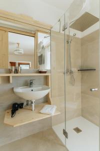 a bathroom with a sink and a shower at Locanda Montana in San Vito di Cadore