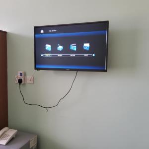 a flat screen tv hanging on a wall at Monrovia Guest House in Nakuru +37 photos