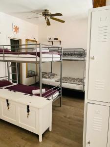 a room with three bunk beds and a ceiling at Kingslanding Old Town Hostel in Dubrovnik