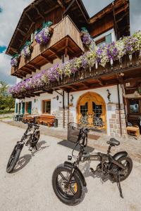 two motorcycles parked in front of a building at Locanda Montana in San Vito di Cadore