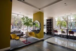 a living room with a large mirror and chairs at Black Sea Central in Odesa