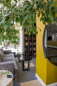 a library with couches and tables and a mirror at Black Sea Central in Odesa