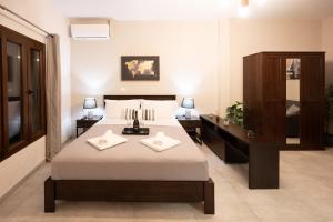 a bedroom with a bed with two pillows on it at Casa en el Lago -Luxury apartments in the historical center of Ioannina in Ioannina