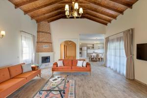 a living room with a couch and a fireplace at Kairos Hotel in Kaş