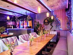 a dining room with a long wooden table and white chairs at EUROLINE HOTEL ODESSA in Odesa