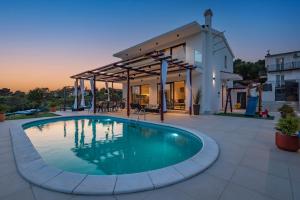 - une piscine en face d'une maison dans l'établissement Villa LucaToni - luxury villa connected with nature - heated pool, à Šibenik