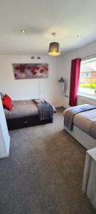 1 dormitorio con 2 camas y ventana en 3 Bed House NG8- Great for Leisure stays or Contractors in the area Close to M1 en Nottingham