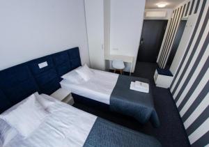 Ένα ή περισσότερα κρεβάτια σε δωμάτιο στο Pokoje - MARINA BORKI