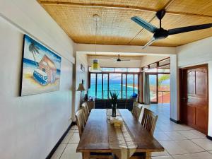 a dining room with a table and a ceiling fan at Lembongan Sanctuary Villas in Nusa Lembongan