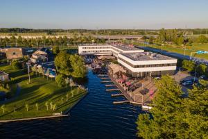 an aerial view of a building next to a river at Leonardo Hotel Vinkeveen Amsterdam in Vinkeveen