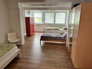 a dorm room with two beds and a window at My-Skypalace Neckarsulm in Neckarsulm