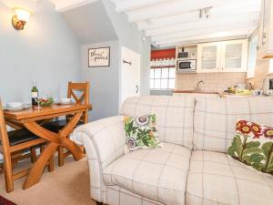 a living room with a white couch and a table at Clover Cottage - Delightful 1-bed cottage in the heart of Ambleside in Ambleside