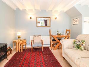 a living room with a couch and a table at Clover Cottage - Delightful 1-bed cottage in the heart of Ambleside in Ambleside