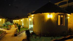 a house with lights on the side of it at night at Seven Sky Clarks Exotica in Bhuj