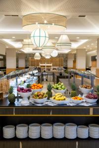 a buffet line with bowls of fruits and vegetables at Puerto Antilla Grand Hotel in Islantilla