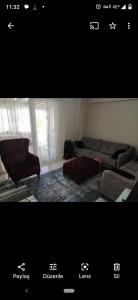 a living room with a couch and a chair at Avşa kiralık yazlık ev in Marmara
