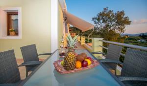 een fruitschaal op een tafel op een balkon bij Green Lagoon Villa by "elite" in Zakynthos