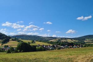 a view of a small town in the hills at Rotmilanblick in Bischofsheim an der Rhön