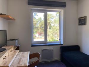 a living room with a couch and a window at Roja apartment Baltic in Roja