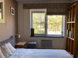 a bedroom with a bed and a window at Roja apartment Baltic in Roja