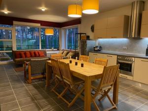 a kitchen with a table and chairs and a couch at Roja apartment Baltic in Roja