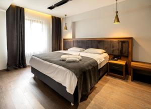 A bed or beds in a room at Türkler Suite Hotel