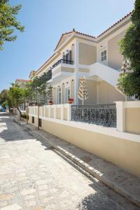 a house on a street with a sidewalk at Doryssa Theorem Hotel in Pythagoreio
