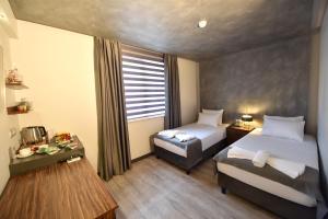a hotel room with two beds and a window at Sunflower Otel in Trabzon