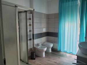 a bathroom with a toilet and a sink at Casa Dany in Albissola Marina +2 photos