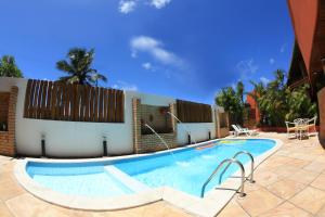 a swimming pool in front of a building at Garbos Soleil Hotel in Natal