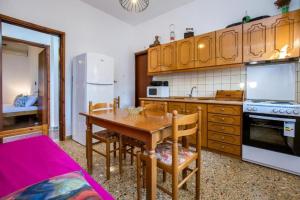 a kitchen with a wooden table and a dining room at Xanthi's Dream Place in Potos