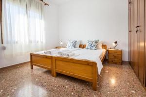 a bedroom with a large bed and a window at Xanthi's Dream Place in Potos