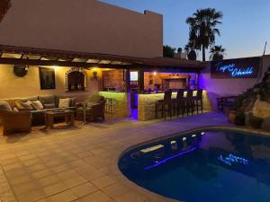 a resort with a swimming pool and a bar at Casa Paraiso Villa Tenerife, stunning family bungalow with totally secluded pool area, wheelchair friendly in San Miguel de Abona