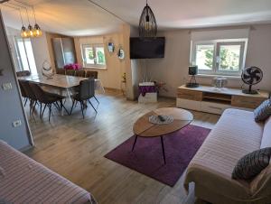 a living room with a couch and a dining room at Villa Rosa in Umag