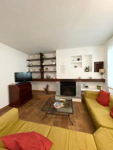 a living room with a couch and a fireplace at Villa Mia Lugano Lake in Brusimpiano +31 photos