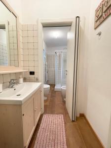 a bathroom with a sink and a toilet at Villa Mia Lugano Lake in Brusimpiano