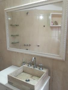 a bathroom with a sink and a mirror at San Cayetano in San Salvador de Jujuy