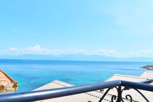 a view of the ocean from a balcony at Apartments Xenios Zeus 1 in Koroni