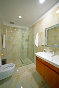 a bathroom with a shower and a sink and a toilet at NBT Hotel Reps in Kukës