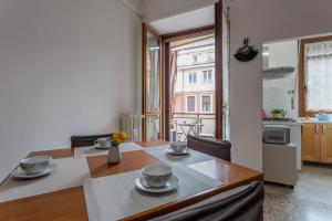 uma cozinha e sala de jantar com mesa e cadeiras em A Casa di Enza by Wonderful Italy em Turim