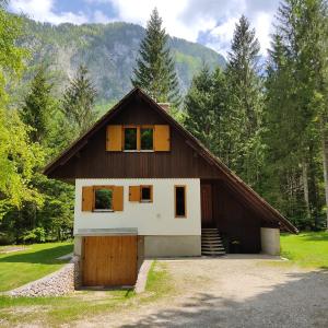 a house with a gambrel roof and a garage at Chalet Via Mons in Mojstrana