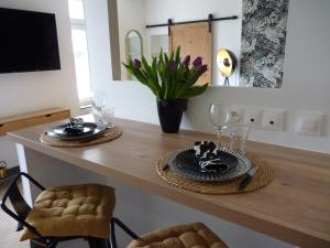 a dining room table with a plate of food on it at Gite Les Matines in Sebourg